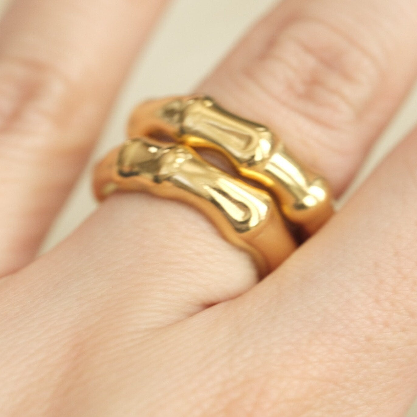 a close up of a person wearing a gold ring