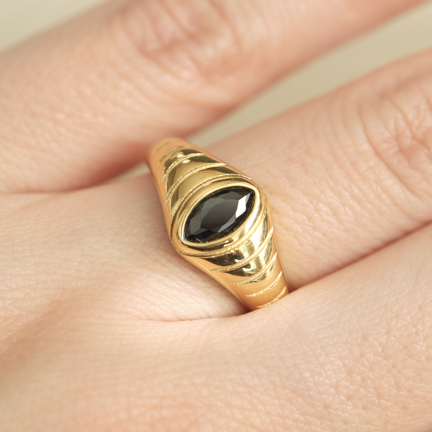 a close up of a person's hand with a ring on it