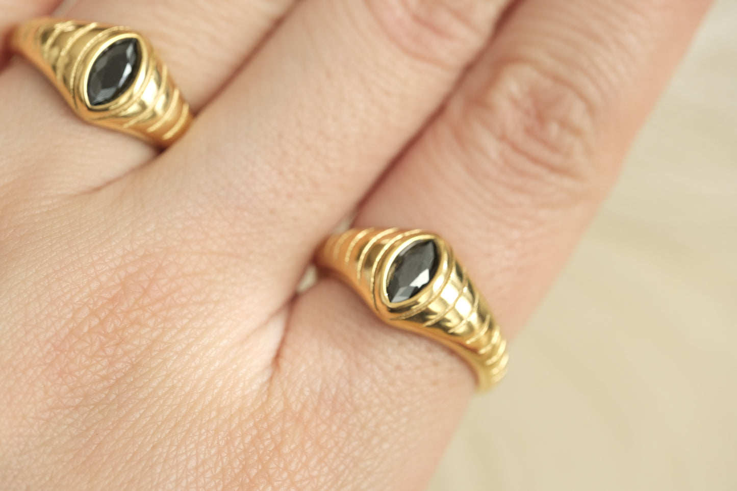 a close up of a person's hand with a ring on it