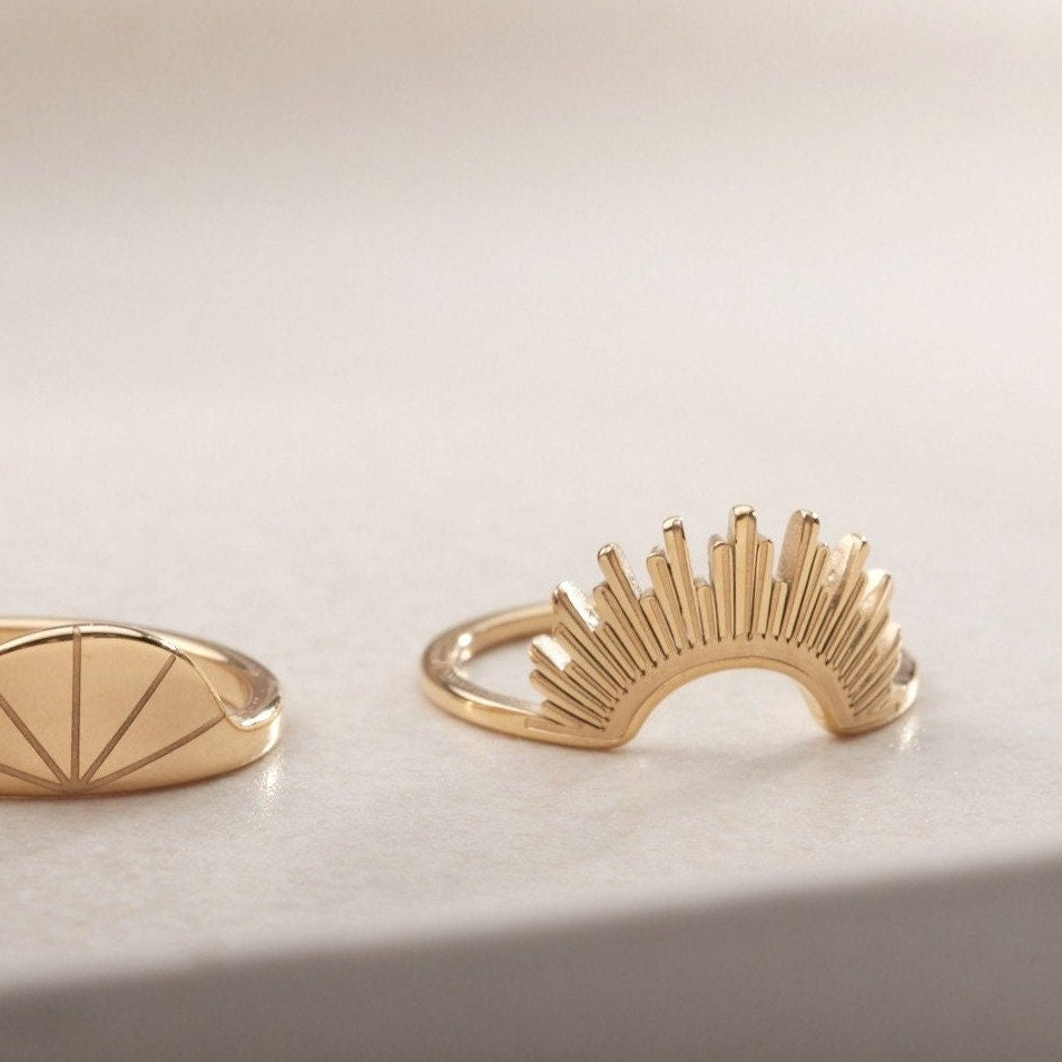 a pair of gold rings sitting on top of a table