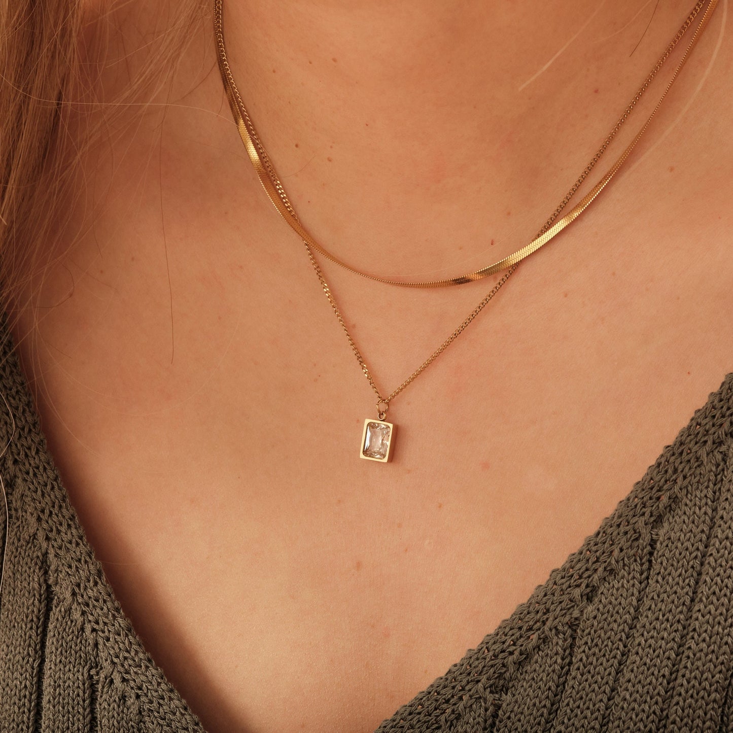 a close up of a woman wearing a necklace